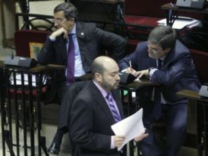 El juntero popular Eduardo Andrés pasa por delante de Bilbao (a la izquierda) y el portavoz foral, Juan María Aburto, en un momento del pleno celebrado ayer en Gernika.