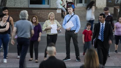 In Madrid, people wait for their Spanish nationality applications to be processed.