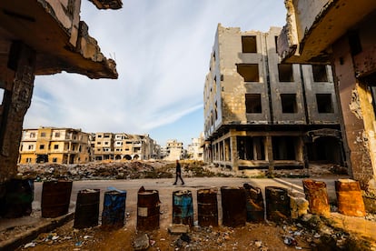 Una persona camina por una calle de Deraa, en uno de los barrios destruidos por los ataques del ejército de Bachar el Asad realizados en 2018. Deraa en ese momento era el bastión de la oposición al régimen en el sur de Siria.