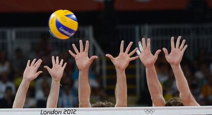 Los jugadores de Brasil intentan coger la pelota durante el partido de voleibol cpntra Rusia.