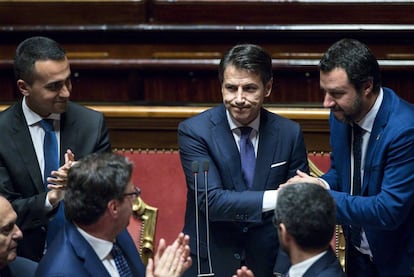 El primer ministro, Giuseppe Conte (en el centro), estrecha la mano de Matteo Salvini. 