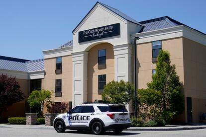 Town of Newburgh police vehicle sits parked outside The Crossroads Hotel, where two busloads of migrants arrived hours earlier