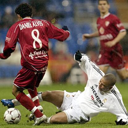 Ronaldo intenta desde el suelo hacerse con el balón en pugna con Daniel Alves.