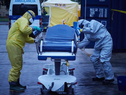 Volunteers disinfect ambulance equipment at the Navarre Emergency Hospital.