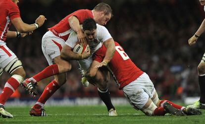 Dos jugadores de la selección galesa tratan de placar al inglés Brad Barritt.