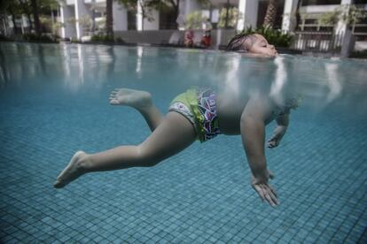 La pequeña Kiara Belle Kit, de un 1 año y 9 meses de edad, nada en una piscina en un intento de batir el récord nacional de mayor distancia a nado en bebés, en Kuala Lumpur (Malasia).