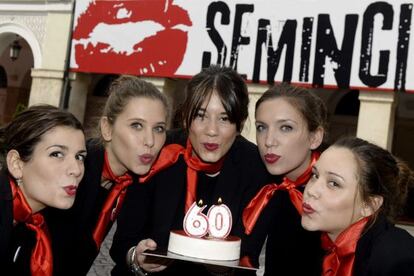 Un grupo de azafatas de la Seminci sopla las velas de una tarta para celebrar el 60ª aniversario del festival.