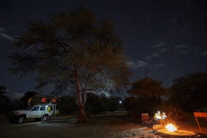 Family by campfire, Nxai Pan National Park, Kalahari Desert, Africa