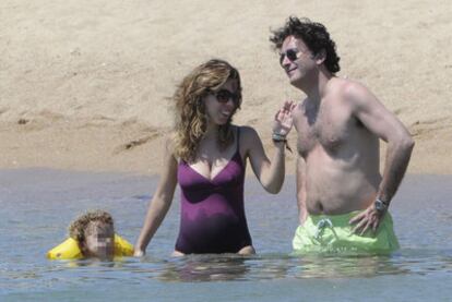 Ana Aznar y Alejandro Agag, ayer con uno de sus niños en una playa de Cerdeña.