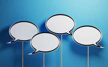 White Chat Bubbles With Wooden Sticks On Blue Background