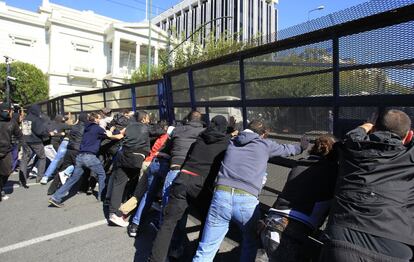 Manifestantes tratar de vencer una barrera policial que protege el Parlamento griego.