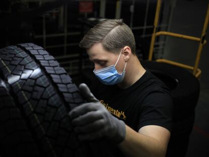 Un trabajador inspecciona un neumático de automóvil en el centro de distribución de Continental Tire, en marzo.