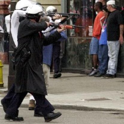 Policías de Cincinnati apuntan con sus armas a un grupo de manifestantes, el martes en el centro de la ciudad.