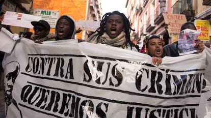 People hold banners during a gathering to protest against the death of the street hawker Mame Mbaye in central Madrid neighborhood of Lavapies, on Saturday 17th, March 2018. Mame Mbaye died while escaping from Police.