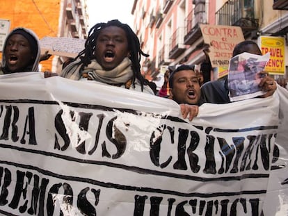 People hold banners during a gathering to protest against the death of the street hawker Mame Mbaye in central Madrid neighborhood of Lavapies, on Saturday 17th, March 2018. Mame Mbaye died while escaping from Police.