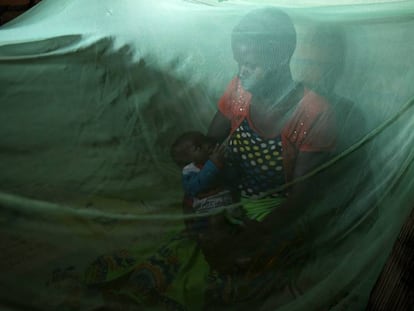 Violet Wilson y su hijo de cinco meses descansan debajo de una mosquitera en su casa de Nkwazi, Malawi.