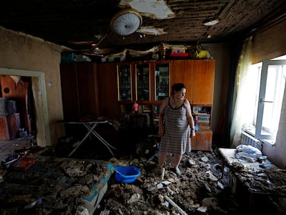 A local resident stands inside her house damaged by recent shelling in the course of Russia-Ukraine conflict in Donetsk, Russian-controlled Ukraine, on August 8, 2023.