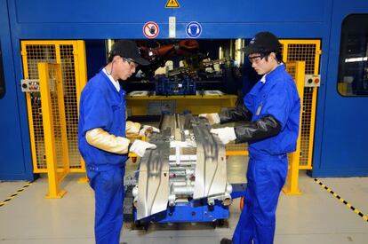 Workers at a factory belonging to Spanish firm Gestamp in Jiangsu.