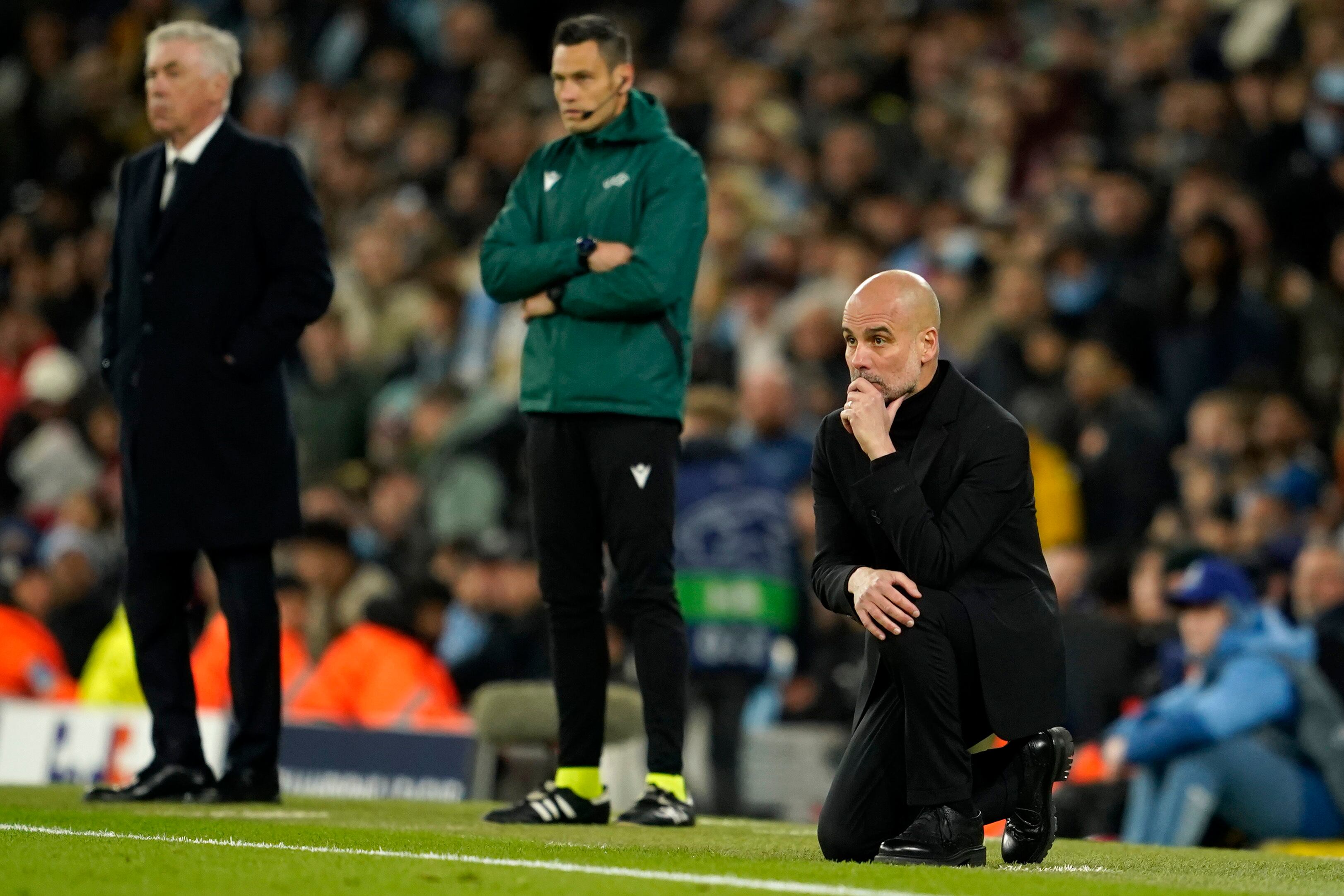 Carlo Ancelotti, entrenador del Real Madrid y Pep Guardiola, entrenador del Manchester City siguen el partido en la banda.