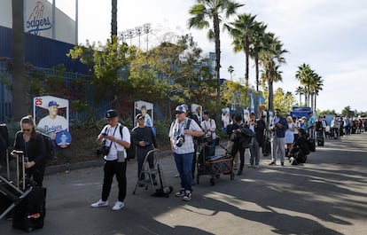 Journalists wait in line at Dodgers Stadium for the Shohei Ohtani press conference.