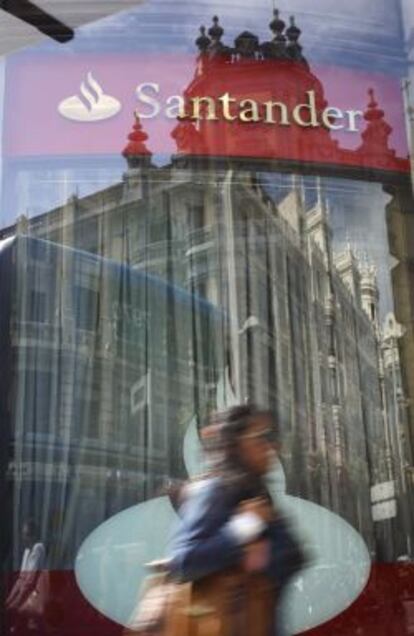 People walk by a Santander bank in Madrid