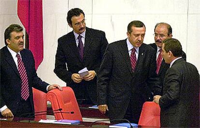 El primer ministro turco, Recep Tayyip Erdogan, en el centro, tras ser confirmado en su puesto ayer por el Parlamento.