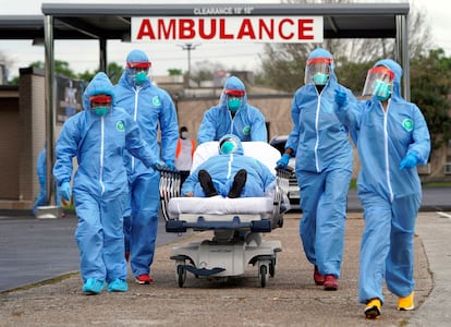 Person in stretcher being taken into the United Memorial Medical Center after going through testing for COVID-19, at the beginning of the pandemic.