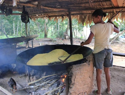 A última parte do processo da farinha de mandioca é passar a massa pelo "forno", como os quilombolas chamam a panela de ferro que se encaixa no semi-círculo de barro onde colocam a lenha. Com uma espátula de madeira se mexe até que a farinha fique dura e seca, em flocos.