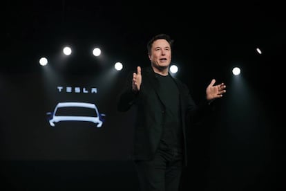 FILE- In this March 14, 2019, file photo Tesla CEO Elon Musk speaks before unveiling the Model Y at Tesla's design studio in Hawthorne, Calif. Musk is buying $10M of the electric vehicle maker’s common stock, shortly after saying the company may need to raise money again. Tesla is offering $650M of common stock and $1.35B in convertible senior notes due 2024 in two separate offerings. (AP Photo/Jae C. Hong, File)