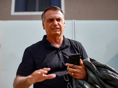 Former Brazilian President Jair Bolsonaro gestures while standing in front of his house before testifying to the Federal Police in Brasilia, Brazil, February 22, 2024.