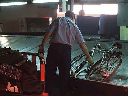 Un operario recoge equipaje en el aeropuerto de Barajas.