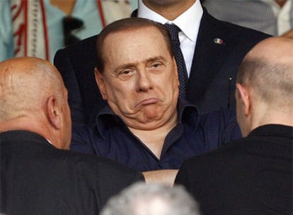 El primer ministro italiano, Silvio Berlusconi, asiste a un partido de fútbol del Milán en San Siro.