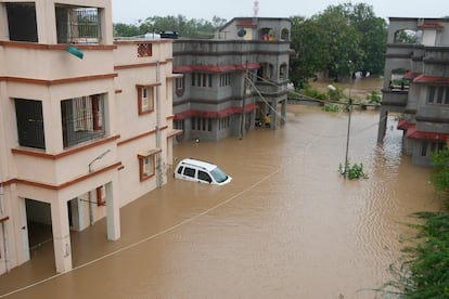 A car is seen partially submerged in the compound of residential quarters of civil hospital employees following heavy winds and incessant rains after landfall of cyclone Biparjoy at Mandvi