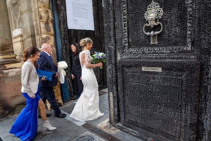 A bride passing through the charred door of Bordeaux City Hall on Friday.