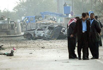 Policías iraquíes inspeccionan los destrozos causados por uno de los ataques de ayer en Kerbala.