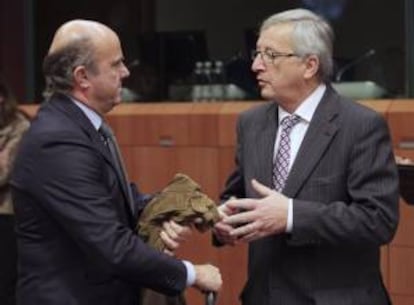 El ministro de Economía de España, Luis de Guindos (izda), conversa con el presidente del Eurogrupo, Jean-Claude Juncker, antes de la reunión de los ministros de Economía y Finanzas de la Unión Europea (Ecofin), en la sede de Bruselas, Bélgica. EFE/Archivo