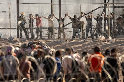 A U.S. Border Patrol agent body searches immigrants at the U.S.-Mexico border on May 12, 2023 in El Paso, Texas