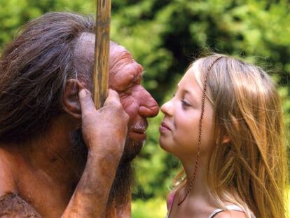 A child peers into the eyes of a model of a Neanderthal man.