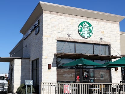 Customers line up at a drive thru at a Starbucks in Austin, Texas, USA, 05 December 2023.