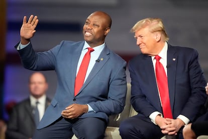 Republican presidential candidate former President Donald Trump looks to Sen. Tim Scott, R-S.C., during a Fox News Channel town hall Tuesday, Feb. 20, 2024, in Greenville, S.C.