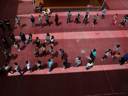 Personas esperando para votar en Santiago de Chile.