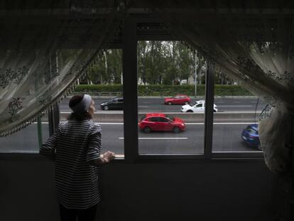 Naime Sajit looks out of her home onto the Extremadura highway in Madrid.