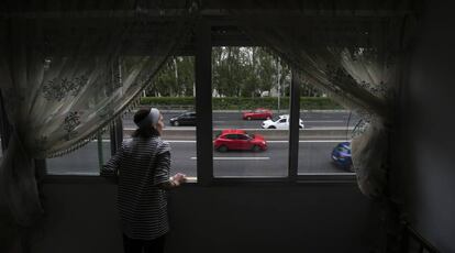 Naime Sajit looks out of her home onto the Extremadura highway in Madrid.