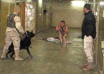 Dos soldados estadounidenses aterrorizan a un preso en la cárcel de Abu Ghraib, cerca de Bagdad.