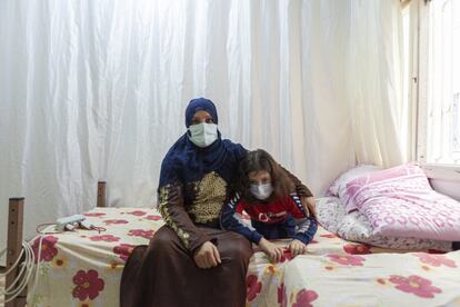 Nishreen Qash junto a Abdalá en su habitación de Reyhanli. Pasan aquí los días, ya que tienen pocos recursos y en todas las escuelas que hay cerca enseñan en turco. Nishreen asegura que reciben 120 euros al mes, pero que envía la mitad a Siria, donde aún viven su marido y padre de Abdalá, Abu Hasan, y sus demás hijos, Mohamed y Asma, de 14 y 17 años.