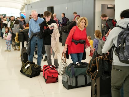 Travelers wade through the line to drop off bags at the Southwest Airlines check-in counter at Denver International Airport, Dec. 27, 2022, in Denver.