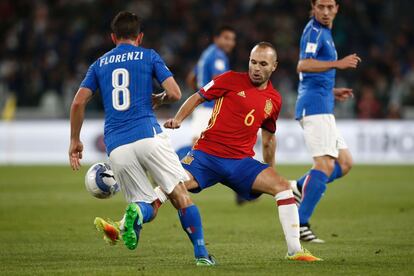 Andrés Iniesta de la selección de España se apodera del balón durante una jugada con Alessandro Florenzi de Italia.