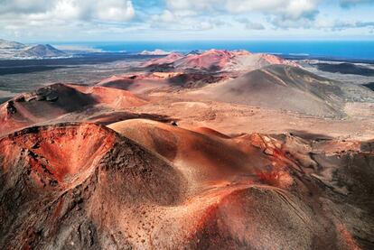 The Timanfaya national park is made up of a number curious geological structures, which were formed following the volcanic eruptions between 1730 and 1736 and in 1824. Visitors can appreciate the alien-like mix of pinks and oranges against the silhouette of over 25 volcanoes, with the blue sea behind.