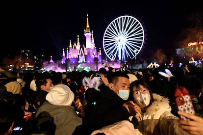 Dos jóvenes se fotografían durante la cuenta atrás para el Año Nuevo en un parque de atracciones de Pekín, China.