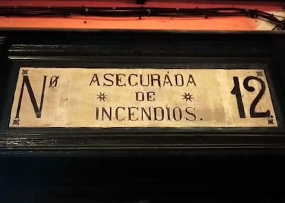 A plaque on a building in Madrid says it is “insured for fire.”